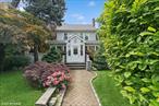 Welcome to this lovely, light-filled, impeccably maintained five bedroom, four bath Colonial, gracefully positioned on a beautifully landscaped corner lot and surrounded by lush privacy hedges. Nestled on a quiet, tree lined street, this residence offers the perfect blend of tranquility and convenienceâ€”just minutes from Bell Boulevard, the LIRR, restaurants, and local parks.Extensively renovated in 2017 this move in ready home features a new roof and windows (just 2â€“3 years old). Inside, you&rsquo;ll find gleaming hardwood floors throughout, a spacious first floor bedroom, a cozy fireplace, and an open-concept living and dining area. The kitchen boasts updated cabinetry and appliances, classic subway tile backsplash, and elegant quartzite countertops. Bathrooms are equipped with new updates as well. With five bedrooms, a den, and a fully finished basement with private entrance, this home offers abundant space, flexibility, and comfort for todayâ€™s lifestyle.Whether you&rsquo;re commuting to the city or enjoying a quiet evening in the garden, this exceptional property offers the best of both worldsâ€”serene suburban living with easy access to everything you need