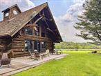 â€œMeadow Lodgeâ€ is a unique private retreat on a scenic rise with stunning Western Catskills and meadow views. The dramatic Adirondack-style, authentic log cabin features massive timbers, a soaring Great Room with stone fireplace, huge windows and glass doors opening to a wraparound deck, all set amidst 44 magical acres of rolling fields and woodland. The open-concept layout includes a renovated chefâ€™s kitchen with quartz counters and new appliances, and a spacious dining area. The lofted primary suite boasts sweeping views, a TV nook, and a light-filled bath with soaking tub. The renovated lower level offers a media room with wood stove, guest bedroom, full bath, laundry, and storage. Extensive upgrades include central A/C, Pella windows, Starlink internet, Nest systems, and whole-house UV air and water purification. The magical grounds include: raised beds, berry bushes, fruit trees, a pond, playset, and mowed walking paths through wildflower meadows, while the separate modern studio with garage door, split unit, and lounge offers creative space or the potential for a wonderful guest house. A truly special turnkey country escape.