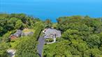 Imagine your own private oasis on the North Fork. This one-of-a-kind custom 4, 500 sq ft Sound front home offers sweeping water views and sits on 2.4 acres of lush with an in-ground pool & spa surrounded by lush landscaping. A long, private driveway welcomes you, enhanced by the serene sound of a waterfall at the entrance.Step inside this meticulously maintained home to discover an open floor plan designed for grand entertaining. The waterside living room boasts a vaulted coffered ceiling and a cozy fireplace, while the huge kitchen is a chef&rsquo;s dream with its Sub-Zero refrigerator, Wolf range, and waterside breakfast area. A butler&rsquo;s pantry/wet bar connects the great room and dining room, making hosting effortless.Experience seamless indoor-outdoor living as waterside rooms open to an expansive deck that gracefully transitions into stone patios and seating areas near the pool. Closer to the water, you&rsquo;ll find an outdoor cooking area, bar, and fire pit, perfect for enjoying the breathtaking surroundings.This home offers ultimate comfort with a first-floor master bedroom suite and an additional one on the second floor. All bedrooms are en-suite, ensuring privacy and luxury for everyone. A convenient attached 3-car garage is also included.Beyond your private retreat, miles of sandy Sound beach stretch as far as the eye can see. All of this is nestled within the bucolic North Fork Wine Country, offering easy access to charming vineyards, farm stands, and renowned restaurants. Don&rsquo;t forget the sunset views every evening. Need we say more? If you want it all, this house has it.