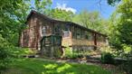 Log style ranch home on almost an acre with a detached 2 car garage. Large open living room with cathedral ceilings and massive floor to ceiling fieldstone fireplace.