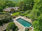 Two Ponds. Long, gated drive to perfect privacy. Spectacular Arts & Crafts Style Estate. Handsome Stone and Shingle facade with peaked roof and massive pillars. Designed by local architect Ralph Mackin and built by Danny Devito in 2002. Approximately 5000 square feet of living space. Stunning interior spaces with fabulous detailing, floor-to-ceiling stone fireplaces, raised paneling and incredible millwork. Perfectly scaled rooms for entertaining yet completely comfortable for everyday living. Entrance Hall with stone fireplace and beamed ceiling. Phenomenal Great Room with vaulted ceiling, impressive floor-to-ceiling stone fireplace and two sets of French doors to the rear terrace. Chefâ€™s Kitchen open to the octagonal Dining Room with vaulted ceiling and beadboard detailing. Paneled Media Room. First Floor Primary Suite with Sitting Room and luxurious Spa Bath. Spacious Loft with Reading Room and large Bedroom Suite with Bath. Stone terrace with firepit overlooking two scenic ponds. Two Guest Houses. Pool with spa, outdoor kitchen, outdoor shower and Pool House. Nearly eight acres adjoining the protected lands of the 4315-acre Pound Ridge Reservation. The perfect family compound or peaceful retreat.