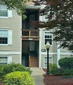 Beautiful END unit with balcony, that has been well maintained AND updated over the years! Updates include: new heating and cooling system within the last year, new HW heater, gorgeous KraftMaid kitchen with large self-close drawers & cabinet doors, glass tile backsplash & granite counters, all in impeccable shape. Newer stainless fridge, gas oven, microwave/vent & dishwasher. Bathrooms have been both been updated with new faucet fixtures, and floor to ceiling glass tile in primary, ensuite bathroom. Second bedroom was used as a large walk-in closet by a previous owner, with custom cabinetry & shelving. Owner will remove it all before closing, if buyers want to use that room as a 2nd bedroom or office again. Newer carpet in both bedrooms, and newer wood flooring throughout living & dining area. Community pool & clubhouse located directly across the street, as well as tennis courts close by. Large entertainment unit in living room can stay, or owner will have it removed before closing if need be. Great complex for walkers & is pet friendly as well! This is a gem of a condo, with only 8 steps to your entry door! All Units come with 1 assigned parking spot, as well as 1 open spot. Complex is also on the commuter bus route to NYC!