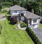 Welcome to this beautifully maintained Colonial-style home offering over 4, 000 square feet of comfortable living space. This thoughtfully designed property features 4 bedrooms and 3.5 bathrooms, including a primary suite on the main floor and a second primary bedroom upstairs.The sun-filled great room with a cozy fireplace flows seamlessly into the generous eat-in kitchen, complete with quartz countertops and stainless steel appliancesâ€”perfect for both everyday living and entertaining guests.Downstairs, the newly finished basement includes a full bath and offers abundant space for a recreation area, home office, or guest suite. The home has 2 zones for the central air conditioning and two heat zones. Recent upgrades include a new Andersen sliding door leading to the deck, a 4-year-old gas furnace hot water heater, and a roof thatâ€™s less than 9 years old.Enjoy outdoor living in the deep 200-foot backyard, ideal for relaxing, gardening, or entertaining. The home also includes a 2-car garage and a driveway that accommodates 4 vehicles.Close to schools, train station, shops, restaurants, and major highwaysâ€”making this home as convenient as it is comfortable.