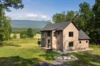 Modern Mountain Escape - Stylish, Efficient, Minutes to CatskillSurrounded by nature and just 8 minutes from the charming Village of Catskill, this 3BR, 2.5BA modern home offers 2, 100 sq ft of intentional design and easy living. Built in 2020, it features radiant heat floors, heat pumps, on-demand hot water, and high-performance insulation for year-round comfort and efficiency.Clean lines, wide-plank wood floors, handcrafted built-ins, and Andersen windows frame serene views from every room. The open kitchen shines with a large island, open shelving, and modern appliancesâ€”perfect for hosting or daily living. Spa-like baths, serene bedrooms (including a treetop retreat upstairs), and a finished walkout basement add to the home&rsquo;s thoughtful layout.Set on a peaceful lot that borders Kiskatom Creek, with open skies and mountain views. Just 17 minutes to Hudson & Amtrak, 15 to Saugerties, and 25 to the iconic Village of Woodstock. Skiing at Hunter or Windham is just 20-30 minutes away. A turnkey modern home in the heart of the Catskills.