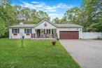 A Hidden Retreat in Patchogue!Tucked away on over an acre of land, this stunning home offers seclusion, serenity, and spaceâ€”all just minutes from the heart of Patchogue. Set far back from the road, the approach reveals timeless curb appeal, featuring a durable Ipe wood deck and a beautifully coordinated garage door. Step inside and be greeted by soaring vaulted ceilings, skylights, and rich Brazilian cherry hardwood floors that flow through the formal living and dining rooms with Granite counters in the kitchen. The expansive great roomâ€”with its dramatic ceiling height and walls of windowsâ€”is filled with natural light and is perfect for entertaining or relaxing in style. The spacious primary ensuite also features vaulted ceilings, creating a tranquil retreat with a sense of openness and airiness. Off the main living area, sliding doors lead to a multi-level Trex deck, where you can bask in complete privacy or enjoy the enclosed Jacuzzi year-round. The full basement offers high ceilings, an interior and garage entrance, and ample space for storage, recreation, or future finishing. Insulated garage door 3yrs old. New bedroom carpet. If you&rsquo;re seeking a private, high-quality home that combines nature, luxury, and convenienceâ€”this is the one.