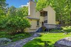 Tucked away on a scenic country road just minutes from historic Woodstock, this stunning contemporary home offers the perfect balance of privacy, tranquility, and access to nature. Set on six acres in a highly desirable neighborhood, this serene retreat is surrounded by lush woods, artfully landscaped grounds, and a feeling of peace that begins the moment you arrive. With nearby hiking trails, Cooper Lake, and epic homes lining the way, the location is unbeatable. Spend your days by the pool, lounging on the stone patio, or unwinding under the stars from one of three decks. Thereâ€™s even an outdoor shower for that perfect post-hike rinse or swim.Inside, the homeâ€™s open-concept main level is flooded with natural light and designed for comfort and easy living. Vaulted ceilings and a striking fireplace anchor the living room, while custom woodwork and sleek cement kitchen countertops add modern flair. Two bedrooms are located on the first floor, including a spacious primary suite featuring a private den and a spa-like bathroom for ultimate relaxation with two additional bedrooms upstairs. A full basement offers excellent storage or potential gym space. Whether you&rsquo;re seeking a weekend getaway or a full-time sanctuary, this property has everything you need to live your best country life.