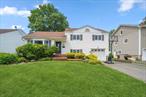 SYOSSET. Do not miss out on this incredible south-facing expanded 3-bedroom, 2-bathroom home in the heart of Syosset. Set mid-block on a quiet residential street, the home welcomes you with a spacious layout and flexible living spaces. At the center of the home is an eat-in kitchen with updated stainless steel appliances, ample cabinetry, and room for casual dining. First floor is completed by a formal dining room and living room. Upstairs, the primary suite is thoughtfully designed with a generous bedroom, and a large en suite bathroom with a spa-like atmosphere. Two additional bedrooms are well-proportioned and share an updated full bathroom. The lower level offers more space for a den or office, as well as laundry and storage. Outside, enjoy a private backyard perfect for entertaining, gardening, or relaxing in the sunshine.