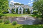 Privately nestled behind gates on 2.89 lush acres, this classically updated 8-bedroom, 9.2-bath New England Colonial offers unmatched elegance, space, and serenity. With a picturesque natural pond in front and sweeping golf course views in back, this estate is a rare and refined offering. From the moment you arrive, the charm is undeniable â€” from the stately approach to the beautifully maintained grounds. Inside, the first floor features a formal living or greeting room, a richly paneled library with bespoke millwork, a private office with custom built-ins, and a spectacular great room/game room perfect for large-scale entertaining or intimate gatherings. The formal dining room is graciously sized for hosting and filled with natural light. At the heart of the home is the dream kitchen: Christopher Peacock cabinetry, an oversized island, two Sub-Zero refrigerators, two Bosch dishwashers, and seamless flow into the adjacent family room with fireplace and French doors leading to the expansive covered patio. Upstairs, discover four ensuite bedrooms, two additional bedrooms with a Jack-and-Jill bath, and a luxurious primary suite with a fireplace, private terrace, spa-like bathroom, custom dressing room, walk-in closet, and an additional full bath. The finished lower level is designed for recreation and relaxation, featuring a full home theater, gym, guest suite, game room, TV lounge, and abundant storage all beautifully finished and thoughtfully arranged. Outdoors, enjoy resort-style living with a sparkling pool and spa, perfectly manicured lawns, mature perennial gardens, and a full pool house with kitchenette, full bath, and laundry. This estate is a rare blend of timeless design, modern luxury, and extraordinary setting â€” a true one-of-a-kind offering.