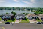 Beautiful move in ready home in N. Woodmere, w/ Hewlett-Woodmere school district. 4 Bd 2.5 bath backing Motts Creek with inground gunite swimming pool. Home was converted to gas and has solar panels. Nest heating system and cambridge pavers.