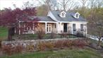 First time for sale in over 50 years, this charming Cape Cod style home is positioned on a spacious 0.7-acre lot with picturesque lake access.2282 sq ft home space, including two bedrooms and 2 1/2 bathrooms, ideal for both everyday comfort and hosting guests. Built in 1965, this home blends classic architectural details with modern amenities, featuring a finished basement with a kitchenette and an attached drive-under 2-car garage. The 1st floor features vaulted ceilings with exposed beams, and the kitchen boasts stainless steel appliances, including a 36-inch Viking range and a stainless-steel wall oven. 1st floor bathroom has Whirlpool tub and dual vanities. 2nd floor bedroom area with bathroom and dual vanities. While not directly lakefront, the home is part of the exclusive Tomahawk Lake community offering coveted amenities like private beach, playground, basketball court, and tennis court enjoy the peaceful rural charm of Blooming Grove while still being commuter-friendly, with easy access throughout 94 nearby bus and train routes along with New York City connections.