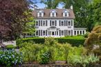 Located in the Beechmont neighborhood of New Rochelle, this center hall colonial home sits on 0.62 level acres and includes a circular driveway and a three-car garage. The entrance features a portico leading to a spacious foyer. The first floor has 9-foot ceilings and includes a living room with a wood-burning fireplace, a powder room, a family room with a fireplace, a sunroom, a large home office, an eat-in kitchen with an island, a butlerâ€™s pantry, a mudroom, and sliding glass doors that open to the patio and backyard. The second floor consists of the primary suite with a fireplace, walk-in closets, an ensuite bathroom, and a balcony, a very large second bedroom with custom closets and an ensuite bathroom, a third bedroom also with ensuite bathroom and a fourth bedroom. The third floor has two additional bedrooms, a great room, a hall bathroom with a tub/shower, and several additional rooms. The unfinished basement offers a laundry room, a 2000-bottle wine cellar, and utility spaces. This home provides ample space for visitors. Come see!