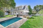 Nestled on a peaceful street in the idyllic village of Southampton, this timeless Hamptons gem blends luxury and convenience across 2, 552 square feet of thoughtfully designed living space. Featuring 3 spacious bedrooms and 2.5 bathrooms, the home welcomes you with sun-drenched interiors, rich dark hardwood floors, and a seamless layout ideal for both relaxing and entertaining. The inviting eat-in kitchen flows effortlessly into a generous living room anchored by a stunning new bluestone gas fireplace-your cozy retreat on cool coastal evenings. A newly finished basement adds flexible bonus space for work, play, relaxation or future 4th bedroom. Step outside to your private outdoor haven: a beautifully landscaped yard with a bluestone patio, an outdoor shower, and ample space for a pool-THE POOL PERMIT IS ALREADY SECURED! Just around the corner, enjoy the brand-new village park featuring a track and picnic areas, perfect for active days and family outings. Located just one mile from the vibrant shops and restaurants of Main Street and two miles from the world-renowned Cooper&rsquo;s Beach, this residence offers the very best of Hamptons living.