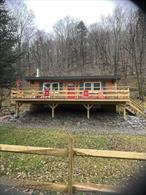 Cozy Cabin with 900&rsquo; of Beaverkill River frontage! Fish, hike, hunt, wade and explore to your&rsquo;s heart&rsquo;s delight! This 2 bedroom / 1 bath rustic getaway sits on a total of 34.31 acres comprised of 4 lots on a lightly travelled gravel road that is town maintained just up to the beginning of the property. There is a private sitting area with a campfire pit along the rivers edge that features a walking path for easy access to stroll along the river bank. While a majority of the property is relatively steep, it does offer a flat spot at the very top with potential for views and is accessible via four wheel drive along a rough mountain drive. There is a powerline easement down the center of the largest 21.33 acre parcel that would allow for ATV trails or wood line hunting and for good measure, there is even an old bluestone quarry with access to usable stone for future projects! Full basement with access doors to the outside allow for easy access to plumbing and electric. This charming single family home located at 989 Chiloway Rd, Roscoe, NY offers a cozy retreat nestled on a spacious, peaceful and serene atmosphere.