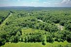 Attention investors, homebuilders, recreationalists, and dreamers alike!Imagine owning 22.3 acres of prime Ulster County land â€” where nature, convenience, and opportunity converge â€” and itâ€™s priced to sell! Whether youâ€™re envisioning a private country retreat, a family compound, a creative commercial venture, or simply a peaceful place to pitch a tent and unwind, this unique offering invites a world of possibility.The property includes three separate parcels: an 18.2-acre lot, an adjacent 2.6-acre lot, and a bonus 1.5-acre piece just across the road â€” once home to a large billboard and perhaps ready to be again. The largest lot holds a whisper of local history, having once hosted a beloved fruit stand that served fresh goods to summer camps and travelers along Route 52 between Woodbourne and Ellenville, NY. Though the fruit stand is long gone, a partial concrete pad and a overgrown parking area remain as reminders of days gone by. The old well and septic are hidden amongst the bushes with location and condition unknown and are not being represented by the sellers.Nature lovers will appreciate the mix of open meadows, stone walls, wooded forest, small flowing streams, and even the potential to create a large pond where the waterways meet. The terrain offers both level areas and gentle slopes â€” perfect for building, hiking, or simply letting your imagination roam.With road frontage, easy access, and utilities nearby, this is a rare opportunity to bring your vision to life in the heart of the Catskills. Whether youâ€™re looking for a peaceful escape or a place to build something special, this versatile property delivers.Just minutes from local shops, fine dining and amenitiesâ€” but tucked far enough away to offer true tranquility.Parcels like this â€” with character, history, and potential â€” donâ€™t come along often.
