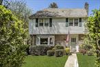 Ideally located just steps from schools, town, and the train, this charming and spacious Colonial is full of character and natural light. The inviting circular floor plan on the main level is perfect for both everyday living and entertaining. Enter through the welcoming front foyer into a bright living room featuring custom built-ins and a wood-burning fireplace. The generously sized dining room, complete with a bay window, flows seamlessly into an expansive eat-in kitchen. A wall of windows floods the kitchen with light, and a side door offers easy access to the side patio and grill. The up-to-date kitchen boasts new stainless-steel appliances and quartz countertops and opens to a cozy family room with built-ins and glass doors that lead back into the living room, enhancing the home&rsquo;s open feel. Upstairs, the second floor offers three spacious bedrooms, two using a hall bath, and the third en-suite primary bedroom. The third-floor features two additional bedrooms and another full bath, perfect for guests, hobbies, or home offices. The above grade lower level includes a powder room and walks out to the private backyard and patio, creating a perfect space for a playroom or second family room. The beautiful backyard connects to a rare private rear lane, a treasured feature of the neighborhood, ideal for bike riding and play, free from through-traffic. This is easy, comfortable living at its best. A must-see home in a truly special location.