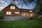 Welcome to your peaceful getaway at the foot of the beautiful Shawangunk Mountains! This charming log home sits on 2.2 acres and features a stocked pond where you will find largemouth bass, sunny&rsquo;s, bluegill fish and carp fed by a cool, natural spring. Pack your fishing rod! Tucked away on a private road, the home offers 1, 968 sq ft of cozy, rustic living space with soaring ceilings in the living and dining areas that make everything open and airy. The living room has a large woodstove, warm wood floors, and fun stenciled details that give it plenty of personality. You&rsquo;ll also find some unique vintage touchesâ€”like a hidden pull-out ironing board and stained glass window in the hallway. Both main level bedrooms have brand-new flooring, both bathrooms have been updated with new vanities and flooring, and the downstairs bath is equipped with a walk-in shower. Enjoy quiet mornings or relaxing evenings on one of the two covered porches. The front walkway and steps were recently redone, and there&rsquo;s a two-car garage under the house with direct access to the basement. As a bonus, the seller is offering a $3, 000 credit toward new appliances. If you&rsquo;re dreaming of a log home retreat, this could be the one! Country living located within the Pine Bush School District.