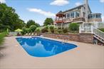 Welcome to an extraordinary 4, 400+ square foot residence in the coveted Warwick School district, where luxury and lifestyle converge to create the ultimate entertainerâ€™s dream. This meticulously maintained and thoughtfully updated home offers breathtaking panoramic views, inviting you to unwind in the serene front atrium or the sun-drenched sunroom at the rear. Step inside to discover a harmonious main floor, where an open-flow layout seamlessly blends with versatile spaces tailored for a home office, music room, or study. Freshly painted in a neutral palette, the living room, complete with a TV and Bose surround sound system (included), sets the stage for memorable gatherings. The adjacent kitchen flows effortlessly into a convenient laundry and pantry room, strategically positioned off the garage for easy grocery unloading and discreet meal prep, keeping your entertaining space pristine. Ascend to the upper level, where the master suite serves as a tranquil retreat, boasting brand-new flooring, fresh paint, a modern ceiling fan, and a luxurious 2024-renovated bathroom featuring new fixtures, elegant tiles, and a rejuvenating steam shower. Three additional bedrooms share a fully renovated, contemporary bathroom with sleek fixtures and a walk-in shower, ensuring comfort for family or guests. The walk-out basement, currently a stylish home office, offers boundless potential as a guest suite or multi-generational living space, complete with a private bathroom and dining area for extended stays. The festivities continue outdoors on a private deck and patio, where you can luxuriate in the BRAND NEW hot tub, take a refreshing dip in the pool, or gather around the firepit for sâ€™mores under the stars. Host unforgettable gatherings with the poolside TV, outdoor kitchen, and gazebo bar area, perfect for grilling favorites or crafting cocktails. Nestled just minutes from Harriman, Legoland, Woodbury Commons, and major shopping, with easy access to train and bus lines, this home offers both seclusion and convenience. A scenic drive to the charming Village of Warwick and approximately 50 miles to the George Washington Bridge make this an ideal retreat for those seeking a blend of rural serenity and urban accessibility. This is more than a homeâ€”itâ€™s a lifestyle.