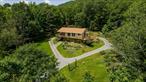 Tucked at the end of a quiet dead-end road just 5 minutes from the village of Margaretville, this private 11-acre retreat offers mountain-top access, stunning views, and a lifestyle close to nature. A well-maintained trail leads through dramatic boulders, eventually connecting to state land for even more hiking and exploration. Ideal for homesteaders and short-term rental income, the property features established gardens, a chicken coop, a large wood shed, a drive-under garage, and a detached 2-car garage for all your gear. The impeccably maintained home includes a finished walk-out basement with a private mother-in-law suiteâ€”perfect for guests or an Airbnb setup. Surrounded by perennial gardens, with breathtaking views from the expansive deck, this home is a peaceful year-round escape. The spacious upstairs primary suite also features its own deck accessâ€”ideal for soaking in the seasonal scenery. The land is made up of three separate tax lots, offering future flexibility for development, resale, or expansion.