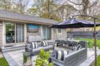 Turnkey style, resort-level amenities, and an unbeatable East Hampton location meet in this newly re-imagined 4-bedroom, 3-bath residence. A boxwood-lined drive sets a gracious tone, opening to abundant guest parking. Inside, a dramatic, beam-studded cathedral ceiling and motorized skylight wash the open living-dining core in natural light. The chef&rsquo;s kitchen pairs sleek cabinetry with top-tier stainless appliances-Bosch refrigerator & dishwasher, LG dual-fuel range, plus matching washer/dryer-while floor-to-ceiling bookshelves frame the adjacent dining area. Three main-level bedrooms are served by two spa-quality baths clad in Thassos marble and designer glass tile. Downstairs, the flexible finished level adds a full gym, a second primary suite, and a contemporary third bath-ideal for guests or multi-generational living. Out back, open skies and lush lawns embrace an 18 x 48 heated saltwater pool, raised garden beds, and fruit trees. The fully equipped outdoor kitchen (refrigerator, sink with hot/cold water, and grill station) plus an electric awning, built-in sound system, and poolside TV turn everyday living into a Hamptons stay-cation. Whole-home upgrades include a high-efficiency Navien three-zone HVAC with on-demand hot water, fiber-optic internet, smart locks & thermostats, security system, 240 V EV charger, and new nitrogen septic sized for six bedrooms. All this sits just minutes by car from East Hampton Village shops, dining, and world-class Atlantic beaches-your modern Hamptons retreat, ready to enjoy from day one.