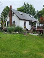 Updated home, hardwood floors, move in ready. The property consist of 3 Lots SBL#23.1-5.1 this lot has a single family home on it, SBL#23.1-5.2 this lot has a mobile home on it that needs to be replaced & SBL#23.-1-3.2 vacant lot. Additional Information: Heating Fuel:Oil Above Ground. Move in ready!