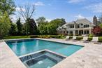 Masterpiece in Old Westbury  Where Transitional Elegance Meets Contemporary LuxurySet on 2 perfectly flat and manicured acres, this custom-built estate is a rare blend of architectural excellence and modern sophistication. Constructed with hand-cut genuine granite stone, a slate roof, and zinc leaders and gutters, every inch of this home speaks to timeless craftsmanship and uncompromising quality.Inside, dramatic design moments unfoldâ€”beginning with a show-stopping stair tower that cascades from the upper level to the fully finished lower level. Wide-plank white oak floors in a herringbone pattern, extensive millwork, and exotic stone and marble throughout set a tone of refined luxury.The grand chefâ€™s kitchen is the heart of the home, anchored by a massive center island wrapped in rare Brazilian quartzite, and seamlessly connected to an oversized family room with fireplace and triple French doors leading outdoors. A formal dining room with custom built-ins, archways, and uplighting creates an elegant setting for entertaining.All bedrooms are en-suite, featuring uniquely designed marble-clad bathrooms. The primary suite is a private retreat overlooking the grounds, offering dual dressing rooms, two separate spa baths, and a steam shower. A gas fireplace adds warmth and ambiance to the bedroom. A first-floor library/home office with a gas fireplace provides a quiet, refined workspace.The lower level redefines entertaining with a striking wet bar, wine refrigeration, poker room, media lounge with marble fireplace, state-of-the-art fitness center, and a dedicated steam shower.Additional highlights include Control4 full smart home automation for lighting, climate, security, and audio, radiant heat throughout, soaring ceilings, oversized windows, built-in speakers inside and out, and extensive custom cabinetry.The exterior is equally extraordinaryâ€”featuring a gunite pool and spa with travertine surround and automatic cover, a full-house generator, outdoor fireplace, fire pit, and multiple lounge areas. An outdoor kitchen further elevates the entertaining experience.The full-service pool house/cabana offers panoramic windows that fully open, a full kitchen, full bathroom, laundry, and an outdoor showerâ€”perfect for seamless indoor-outdoor living. The property also includes a heated 3-car garage, a dog spa, and three separate laundry rooms.This is more than a homeâ€”itâ€™s a lifestyle estate for those who demand the absolute best in design, function, and finish.