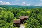 Set on 21 peaceful acres in one of the Hudson Valleyâ€™s most coveted locations, â€˜Dawnbreakâ€™ is an Adirondack-inspired property offering a rare opportunity to create a beloved retreat. With over 3, 200 square feet of living space, this four-bedroom, four-bathroom home combines rustic charm with generous proportionsâ€”ready for your vision to bring it to life.At the heart of the home is a dramatic Great Room featuring soaring ceilings, rich wood paneling, exposed beams, and a wood-burning stove set against a brick chimney. A wall of windows bathes the room in natural light and frames sweeping views of the surrounding hilltop landscapeâ€”an ideal setting for gatherings both large and small.Designed for connection and comfort, the home also includes a welcoming sit-in dining room, a windowed library, and a secondary living area with an adjacent bedroom and separate entranceâ€”well-suited for guests, creative use, or a flexible workspace. Four wood-burning fireplaces throughout the home add character and warmth.The 21-acre setting includes open meadows, wooded areas, and a small creekâ€”an inspiring canvas with room to add a pool, gardens, or outbuilding. A three-bay garage and whole-house generator provide year-round functionality and ease.Located just minutes from the vibrant village of Chathamâ€”close to everyday amenities as well as restaurants, farm markets, and cultural venuesâ€”and close to the Taconic State Parkway, I-90, Hudson Amtrak, and Albany, this is a rare chance to create a one-of-a-kind Hudson Valley escape.Bring your vision and make this Old Chatham haven your own!