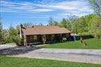 Don&rsquo;t miss this incredible opportunity to live the vacation lifestyle every day. This unique log cabin offers a seamless blend of rustic charm and modern updates, set on three private acres with stunning mountainside views. The heart of the home is a beautifully updated open kitchen featuring an island, breakfast bar, two pantry closets, and direct access to the expansive full length deck-perfect for indoor-outdoor living. A separate dining area and a soaring cathedral-ceiling family room with a striking stone fireplace create a warm and inviting atmosphere for entertaining and everyday living. The main level includes two spacious bedrooms, an updated bath, and a private primary suite with a fully renovated ensuite bath and direct access to the deck. The lower level offers even more space to spread out and enjoy, with a large entertainment room that opens to the backyard, a full bath, a generous laundry area with built-in cabinetry, an ice maker and a private office with sliding glass doors. Step outside into your personal outdoor oasis featuring a built-in pool, hot tub, full bar, putting green, bocce ball court and horseshoe area - designed for year-round enjoyment. A massive detached 35&rsquo; x 36&rsquo; garage with loft space adds unmatched storage and versatility. This property is truly one-of-a-kind retreat designed for comfort, entertainment and unforgettable memories.
