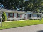Welcome to Foxwood Village- A 55+ Land Lease Manufactured Home Community - Monthly Maintenance is $799 and includes water, septic, garbage pickup, common area maintenance, Clubhouse, Outdoor Pool & Park Area.This beautifully well-maintained home offers 2 Bedrooms, 2 Baths, Front Living Room, Den, Dining Room, Kitchen with Center Island, Breakfast Area, Closet with Washer & Dryer & Garage Access, Sliding Glass Door which leads out to a Deck and a Private Backyard, A Florida Room, Garage with access to attic for storage and Back Utility Room for Crafting, Woodworking, or extra Storage CAC, Sprinkler System, 4 ft Poured Concrete Crawlspace for Dry Storage, Propane cooking, #1 Fuel Oil for heat.  Natural Gas available if you want to convert over.