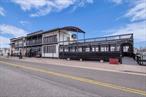 Public RemarksPrime waterfront property fully leased to Catcherâ€™s Fish House & Grille under a NNN lease through January 2025, offering stable income and built-in rent escalations. Includes 17 outdoor boat slips for year-round use, adding direct waterfront appeal in the heart of Freeportâ€™s popular â€œNautical Mileâ€ dining and boating district. Featuring a spacious and inviting interior with floor-to-ceiling windows, plus exclusive outdoor dining decks overlooking serene water views. This offering combines a robust carry-trade opportunity with lifestyle amenities in a high-traffic, maritime-oriented destination.