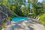 Experience the breathtaking serenity of this exclusive 2.5 acre private hilltop retreat boasting stunning mountain views. Step into the elegance of a gated Sands Mill brick Colonial that checks off every essential on your lifestyle wish list. Impeccable design and timeless style define this residence, accentuated by exquisite architectural details. The heart of this home is a chef&rsquo;s kitchen seamlessly connected to inviting areas, complemented by graceful formal rooms. Two primary suites offer luxurious escapes with newly renovated spa baths, while two additional ensuite bedrooms provide comfort and privacy. The expansive walk-out lower level features an extra guest suite and a three-car garage. Entertainment reaches new heights around the heated grotto pool, carved into a remarkable rock outcropping with a cascading waterfall and spa. This haven is just minutes away from Armonk Square, offering a plethora of amenities, including Main Street&rsquo;s dining and shopping, prestigious golf courses at the Summit and Whippoorwill Clubs, and upscale grocery shopping at DeCiccoâ€™s and Whole Foods. Stay fit with convenient access to Equinox or LifeTime Fitness. Nestled in an exclusive neighborhood, with Byram Hills Schools. Conveniently located near I-684, it&rsquo;s just a 15-minute drive to North White Plains Metro North Station, providing a quick 38-minute commute to Grand Central Terminal.