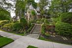 One-of-a-kind Tudor in Hollis Hillsâ€™ prestigious Surrey Estates. This 4 bedroom, 4 bath home sits on an oversized 8, 320 square foot corner lot and blends timeless charm with modern upgrades. Features include hardwood floors, original brass hardware, slate roof, radiant-heated marble and porcelain tile, and a chefâ€™s kitchen with Wolf, Gaggenau, and Miele appliances. Enjoy a formal dining room, sunroom, and custom home theater. Beautifully landscaped yard with stone patios, landscape lighting, and built-in gas line for grilling. Two separate central air systems, full security, and heated 2-car garage. Located in top-rated SD 26 and convenient to express buses, local transit, and major highways. Too many upgrades to listâ€”Must see in person!