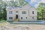 MODERN NEW CONSTRUCTION ON 3.84 ACRES, 2, 300+ SQ FT OF STYLISH, EFFICIENT LIVING IN NEW PALTZ.Designed for todayâ€™s buyer, this 4-bedroom, 3-bath ready to move in home blends clean lines, smart layout, and upscale finishes, offering performance, privacy, and comfort all in one.The main level impresses with high-end wood flooring throughout soaring cathedral ceilings, and an open-concept layout filled with natural light. The gourmet kitchen features quartz countertops, stainless steel appliances, crisp white cabinetry, a large center island, and a bright dining area that opens to an expansive deck with stairs leading to the backyard, ideal for gatherings and summer barbecues. A custom built dramatic focal propane fireplace adds warmth to the spacious living room. The luxurious primary suite offers a tranquil escape with tray ceilings, a spa-like ensuite bath with a soaking tub, dual vanity, and a walk-in closet. Two additional generous bedrooms and a stylish full bath complete this level. The fully tiled lower level offers incredible flexibility with a walk-out family room that leads to a patio, a guest bedroom or dedicated office, a full bathroom, and a separate laundry room, perfect for multigenerational living or remote work. Additional features include a 2-car garage, two separate high-efficiency condensers, each dedicated to its own AC unit, one for the upper level and one for the lower level ensuring customized comfort and energy efficiency throughout the home, peaceful wooded surroundings, and a prime location just minutes from downtown New Paltz, Route 87, local colleges, trails, and cultural hotspots. Donâ€™t miss your chance to own this exceptional Hudson Valley retreat!