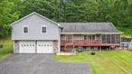 Pristine Tri-Level Retreat with Dream Garage, Gym & Stunning Views!Welcome to your own private paradise! Tucked away on 3.2 serene acres, this custom 4-bedroom, 3-bath tri-level home offers the perfect balance of peaceful living and easy accessâ€”just 20 minutes south of Albany and minutes to I-87.Immaculate inside and out, the home has an open floor plan ideal for entertaining and everyday comfort. Soaring cathedral pine ceilings and gleaming hardwood floors add warmth and charm throughout. The expansive layout includes generously sized rooms, a large rec room, and even a full private gymâ€”your wellness haven at home!Step outside to the 12&rsquo; x 42&rsquo; screened-in porch or host unforgettable gatherings in the outdoor entertaining area. Thereâ€™s even a chicken coop for those dreaming of a homesteading lifestyle!The oversized primary suite feels like its own private retreat, complete with a spa-like bathroom and radiant heat. Cozy up on chilly evenings with radiant heat throughout the basement, main level, and primary bath, plus a pellet stove for added ambiance.Car enthusiasts and hobbyists will love the oversized heated 3-bay garage with a workshop, loft storage, and an additional carport. Whether you&rsquo;re tinkering, storing toys, or dreaming up your next project, this space delivers.All of this backs up to 100 acres of private woods with trails and sweeping views of the Hudson River Valley and the Berkshire Mountains. A rare gem offering space, privacy, and convenienceâ€”you truly can have it all.