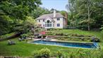 Welcome home to this beautiful colonial, perfectly situated in a spectacular private setting that backs up to the pristine Mianus River Gorge. These original owners thoughtfully designed and customized the home with high-end finishes and exceptional attention to detail throughout. The heart of the home is a recently renovated kitchen, featuring a gas cooktop, custom cabinetry, stone countertops, and a calming natural palette that seamlessly blends style and function.The open-concept family room is filled with natural light from a striking Palladian window overlooking the backyard, and is anchored by a classic wood-burning fireplace that creates a warm and welcoming gathering space. The gracious foyer sets an elegant tone upon entry, flanked by a formal living room ideal for entertaining, and a private den or office perfect for work-from-home needs or quiet study.Upstairs, youâ€™ll find four spacious bedrooms thoughtfully arranged for both comfort and privacy. The luxurious primary suite serves as a true retreat, with a newly remodeled spa-inspired bath featuring a soaking tub, double vanity, and separate glass-enclosed shower â€” creating a peaceful oasis for relaxation. Two separate walk-in closets provide abundant storage and organization. This primary suite is located on the same level as the other three bedrooms, but thoughtfully set apart to ensure privacy and tranquility.A walk-up attic with full flooring provides generous, easily accessible storage, while the finished lower level offers over 1, 000 square feet of versatile space and walks out directly to the pool area.Outdoors, the property is a true showstopper. The beautifully landscaped yard includes a stunning heated 16x54 gunite pool with a solar cover for energy efficiency. This pool area feels like a private resort, surrounded by lush landscaping, mature trees, and classic stone walls that provide both natural beauty and a sense of peaceful seclusion. The spacious patio off the kitchen is ideal for al fresco dining and summer gatherings, while the large, level lawn offers endless possibilities for play and recreation, all set against a backdrop of serene woodland views.Additional highlights include a full-house generator for peace of mind, an oversized two-car garage, and pride of ownership evident throughout. Crisp, fresh, and thoughtfully maintained, this colonial is ready to welcome its next owner to enjoy its exceptional setting and timeless appeal.
