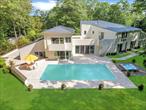 Privately gated and set on 1.42 acres backing to a nature preserve, this 7, 355 SF modern estate offers unparalleled privacy, light-filled interiors, and resort-style amenities. Designed by architect Martin Scheffer (Zurich) and fully reimagined in 2017, the home features soaring cedar ceilings, wall-to-wall sliders, skylights, imported Italian travertine floors, a chefâ€™s kitchen with Miele appliances, 5 bedrooms, home office, indoor and outdoor gunite pools, sauna, artist studio with terrace, and all-weather tennis court. Surrounded by lush gardens and serene beauty, this is luxury Hamptons living at its finest. (Whole House Generator, Whole House Waterfilter System, Whole House &rsquo;Desert Aire&rsquo; Dehumidifier, Cogan System Constructed-superior structural integrity.)