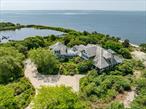 Welcome to Turtle Bay. Experience luxurious waterfront coastal living at Turtle Bay, an exceptional 7, 900+ square foot custom-built residence, nestled on 9.25 acres of pristine land and surrounded by 70+/- acres of protected preserves. Located just 1.5 miles from charming Bellport Village and only 60 miles from Manhattan, this waterfront estate offers the perfect blend of privacy and convenience. This captivating residence showcases an elegant primary suite with panoramic views of the Great South Bay, a private library, butler pantry, a serene garden room, and a spacious three-car garage with epoxy floor topped by a finished guest suiteâ€”perfect as-is or easily transformed into a studio or gym. The home also boasts 360 feet of private beach, offering direct access to the water and breathtaking views. Entertain in style with a covered porch, an outdoor kitchen, and a spectacular infinity-edge pool and spa that seem to melt into the bay. The beautifully landscaped grounds include a tranquil koi pond with waterfall, walking paths, and unmatched natural beauty throughout. Thoughtfully designed for modern living, the home features two washing machines, two dryers, two Subzero refrigerators, and two Miele dishwashers - providing seamless convenience and efficiency for everyday life and entertaining. With an extensive list of upscale amenities and timeless architectural detail, this is a rare opportunity to own a true waterfront sanctuary.