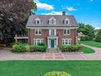 Enter through one of two distinctive wrought iron gates and step into a piece of cinematic history. This stately all-brick Colonial Manor, built in 1914 and featured in multiple films, offers 4, 540 sq ft of timeless elegance across three expansive levels. Situated on nearly a flat acre of beautifully landscaped grounds, the 12-room estate features 5 spacious bedrooms and 3.5 baths. Classic detailsâ€”including original hardwood floors, intricate crown molding, natural gas heating, and four wood-burning fireplacesâ€”infuse the home with warmth and character. Enjoy seamless indoor-outdoor living with two enclosed stone-paved walk-out patios and a second-story terrace overlooking the manicured grounds. French doors throughout the home enhance light and charm, while a three-car detached garage, in-ground sprinklers, and generous closet space add comfort and convenience. While the home invites some updating and TLC, the full unfinished basement and enduring architecture offer a rare opportunity to create your dream estate. Ideally located near the LIRR, buses, and shopping, this is a truly exceptional gem that must be seen.