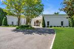Tucked away in the exclusive Village of Kings Point, this stunning estate at 6 Hamptworth Drive offers an unparalleled blend of luxury, comfort, and resort-style living. Set on over 1.17 lush acres, this impressive residence is a unique architectural gem designed for both grand entertaining and serene everyday living. Step inside and be immediately struck by the high ceilings, abundance of natural light pouring through floor-to-ceiling glass, seamlessly blending the indoors with the picturesque garden. Every room feels bright and open, with panoramic views of the beautifully landscaped grounds that create a serene, gallery-like atmosphere throughout. This exquisite home features 5 spacious bedrooms, each with a private en-suite bath, and a total of 4.5 elegant bathrooms. Radiant heating flows throughout the house, ensuring comfort in every season, while a whole house surround sound system enhances both everyday living and special occasions with immersive audio. A grand living room anchored by a stately fireplace invites cozy evenings and sophisticated gatherings alike. The finished basement offers flexible space for a home gym, theater, or recreation room. Outdoors, experience the lifestyle of a private country club right at home. A sparkling swimming pool, full-size tennis court, and expansive patio area make this estate an entertainerâ€™s paradise. For your security and convenience, the home features an all-encompassing surveillance system with cameras covering the entire property. The garage is equipped with a dedicated electric vehicle charger for convenient at-home charging. Whether youâ€™re hosting summer soiree or enjoying quiet weekends at home, the setting is nothing short of exceptional. With a variety of heating options and a whole house generator ensuring year-round comfort, every season here is both luxurious and worry-free. From its light-filled interiors to its resort-caliber amenities, 6 Hamptworth Drive is more than a home â€“ itâ€™s a lifestyle.