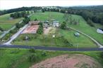 A unique and magnificent opportunity is now available for its next chapter. This 19+ acre property is perfectly positioned for many ventures on a rural corner in the heart of Bethel, NY. The desirable location is agriculturally zoned and was formerly a state-of the art equestrian facility, allowing endless possibilities with numerous outbuildings, pastures and infrastructure. Main house is a duplex with beautifully appointed interiors that can easily be converted into a single family or a multi-generational living space since they are conveniently connected. Each unit offers 3 BR&rsquo;s, open floor plan, washer and dryer. The larger apartment offers 2 full baths, a large entry and a covered porch overlooking the beautiful meadows and pond. Manufactured ranch home is a plus and perfect for rental or caretaker quarters. Main barn houses 10 stalls, tack room, feed room, wash bay (hot and cold water), restroom and utility room for residence above. Three additional Amish-built barns offer 4 stalls each and are scattered throughout the open acres of property. Picturesque setting with pond, stream and trails through the wooded areas is simply magical. Plenty of storage with several other outbuildings including a 4-bay garage and barn with mini-stalls as well as a run-in shed and two open arenas. Property fronts on two roads offering development potential as well as high visibility. Minutes from Bethel Woods Center for the Arts (1969 Woodstock site), Sullivan Catskills lakes, farms, hiking, skiing, craft breweries, distilleries, shops, casino, water park, and more. Only 90 miles to NYC! This is a canvas for a dream lifestyle and business in a historically rich region.