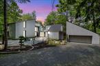Step into a rare and iconic mid-century modern residence, masterfully designed and once inhabited by renowned local architect Dennis Jurow. Tucked away on a private and mature one-acre lot in Middletown, this 4, 000+ square foot home is a true celebration of 1970s contemporary designâ€”thoughtfully preserved with original details throughout. This one-of-a-kind home features ten sliding glass doors that open from multiple living areas, seamlessly connecting the indoors to the lush grounds. Triangular clerestory windows, sunken rooms, soaring ceilings, and built-in cabinetry reflect Jurowâ€™s signature styleâ€”flooding the space with natural light and offering a continuous dialogue between architecture and nature. Design enthusiasts will appreciate the original light fixtures, tile flooring, custom built-ins, and recessed lighting. The residence also includes Jurowâ€™s original architectural office, a wellness room or additional office, and two fireplacesâ€”perfectly blending form and function. Smartly designed with sectioned-off zones for maximizing energy efficiency for heating and cooling. Recent updates include a double oven, cooktop, dishwasher, new carpeting, three HVAC units, a new hot water heater, new pool liner, and roof. This extraordinary home offers a rare blend of architectural integrity, thoughtful updates, and tranquil settingâ€”truly a must-see for those who appreciate exceptional design and craftsmanship.