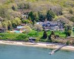 Rarely available in size, scope, and setting, this generational Nassau Point estate is a standout along the Peconic Bayâ€”its beauty long admired by passing boaters. Set on 4.23 acres with over 300 feet of private beachfront, it offers unmatched privacy in one of the North Forkâ€™s most desirable waterfront enclaves. At its heart is a nearly 9, 000-square-foot residence that masterfully blends timeless design with modern functionality. Expansive, light-filled living spaces frame sweeping bay views, while 8 bedrooms and 8.5 bathrooms are thoughtfully distributed across multiple wings for effortless living and entertaining. Amenities include a movie room, home gym, and sauna.A separate two-bedroom, two-bathroom guest cottage adds further flexibility for hosting. Outdoors, a deepwater dock provides direct access to Peconic Bay, while the waterside gunite pool, tennis court, and pool house create a true resort-like experience. The impeccably landscaped grounds are dotted with mature specimen trees and ornamental plantings, offering natural beauty and seclusion throughout.Every detail has been carefully curated to deliver a rare combination of scale, comfort, and coastal luxuryâ€”an offering of enduring significance, whether envisioned as a legacy compound or seasonal retreat.