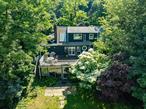 Enjoy Breathtaking Water Views of Roslyn Pond from This Unique Park-like Home! Just one house away from the iconic Bryant Library and picturesque Gerry Park, this spacious and sun-drenched residence offers a bright living room with a fireplace and direct access to a large deckâ€”perfect for relaxing or entertaining. The home features a formal dining room and an updated eat-in kitchen with an oversized quartz center island.Boasting four generously sized bedrooms and three full bathrooms, this home also includes central air conditioning plus six Energy Star split units for efficient year-round comfort. A natural gas connection is already in the house, offering added convenience and potential. The large finished walk-out basement and a rare double-story enclosed porch open to stunning pond views, providing seamless indoor-outdoor living on an oversized lot.Additional highlights include a 1.5-car attached garage, low taxes, and a prime location within walking distance to local restaurants, shops, parks, and the LIRR stationâ€”offering a convenient commute to NYC. Located in the award-winning Roslyn School District. A rare opportunityâ€”priced to sell!