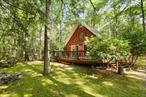 Tucked within the forever-wild private community of Wolf Lake, 16 Canal Road offers the rare combination of convenience and tranquility. This 3-bedroom, 2-bath home sits on the lake side of the road providing deeded lake access just steps away without ever having to cross the street! In just a few steps from you back deck you can bask in the southern exposure on the attached dock or launch a kayak and enjoy the mindfulness of a day on the lake. Inside, cathedral ceilings soar above an open-concept living space, creating a bright and airy atmosphere perfect for lake life. A wraparound deck invites you to take in the wooded surroundings, while a full basement offers storage or expansion potential. This is a lake home balancing comfort, utility and low-maintenance.Wolf Lake is one of Sullivan Countyâ€™s most sought-after lake communities, featuring 1, 800 private acres of untouched forestland, miles of maintained hiking trails, member access to three spring-fed lakes, and a clubhouse with a full calendar of events. Just 90 minutes from the George Washington Bridge. One-time Wolf Lake membership fee: $5, 250. Annual dues: $1, 200.