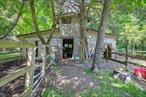 2 acres of horse property, kennel property, or land lovers. 6-stall center aisle barn and one stall in and out. The riding ring is large. The house is very private, set back, and very quiet.