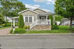 Welcome to Glenwood Village, a 55+ manufactured home community offering comfort, convenience, and a welcoming lifestyle. Nestled in the tranquil Oakwood section, this beautifully maintained home is move-in ready and full of thoughtful upgrades.Step onto the charming covered front porch and feel right at home. Inside, youâ€™ll find 2 bedrooms, 2 full baths, a den/office, and a dedicated laundry area. Hardwood flooring runs throughout, and the kitchen is equipped with stainless steel appliances and a central islandâ€”perfect for entertaining. The kitchen opens to a dining room with an elegant tray ceiling, while a bright breakfast nook sits at the opposite end.The spacious living room flows effortlessly into a flexible den or office space. The conveniently located laundry room offers easy access to the side deck, driveway and backyard shed. The guest bedroom and full bath are generously sized, and the primary suite at the rear of the home boasts a tray ceiling, walk-in closet, and a private en-suite bath. This is truly a must-see home in a peaceful, sought-after community.  Land lease: $725/month.