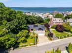 Welcome to this beautifully updated brick ranch-style home in Park Hill, offering stunning Hudson River views and just 20 minutes from Manhattan. This sun-filled residence features an open-concept layout with archways leading to the living room, dining area, and kitchenâ€”highlighted by hardwood floors throughout. The kitchen boasts granite countertops, ample cabinetry, stainless steel appliances, and a breakfast-bar island with a sink and dishwasher. Enjoy seamless indoor-outdoor living with sliding doors to an enclosed sunroom and a spacious patio overlooking a large backyard, complete with an outdoor showerâ€”perfect for future pool or hot tub installation. The primary suite offers a remodeled en suite bath and in-room laundry, while a second full bath features a luxurious double rain shower. Additional highlights include a two-car garage with EV charger, solar panels on a 3-year-old roof, and proximity to Ludlow Metro-North, Van Cortlandt Park, Tibbettâ€™s Brook Park, and the Park Hill Racquet Club.
