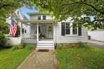 Nestled in the heart of downtown Yorktown Heights, this charming colonial-style home boasts a delightful front porch and a rich history as the original carriage house for the Methodist church. Enjoy the convenience of a short stroll to town, places of worship, and more. The home features beautiful hardwood floors throughout, a living and dining room with exposed beams, and an eat-in kitchen with a pantry and shiplap molding. A powder room and a practical mudroom with laundry facilities lead to the deck, patio, and a fenced yard. Upstairs, three cozy bedrooms share an updated hall bathroom. The full unfinished basement includes Bessler stairs leading to the yard. Modern updates include updated electrical systems, a constant hot boiler mate generator hookup, and a roof approximately 12 years old. A detached one-car garage with a new door completes this property. It&rsquo;s conveniently located near the Taconic State Parkway, shopping, and more.