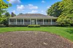 Welcome to this exceptional custom-designed Colonial, perfectly positioned on the crest of a private cul-de-sac in the highly sought-after Oak Park development. Set on .85 beautifully landscaped and wooded acres, this elegant residence offers both privacy and refined living. From the moment you enter, you&rsquo;re greeted by a dramatic grand double staircase that sets the tone for the rest of this impressive home. The main level features a spacious primary bedroom suite complete with a full bath, providing convenience and comfort with first-floor living. A bright sun lite sunroom off of the custom kitchen perfect for relaxing time. Upstairs, youâ€™ll find three generously sized bedrooms sharing a Jack-and-Jill bathroom and an additional half-bath -- perfect for family or guests. Rich hardwood floors flow throughout the main floor of the home, accented by detailed crown molding and timeless craftsmanship. Additional highlights include a full basement offering endless potential and a two-plus car garage. This one-of-a-kind home is conveniently located between the Villages of Patchogue and Bellport with all their amenities including boating, theater, restaurants and nightlife, ferry to Fire Island Golf /Tennis and so much more!!
