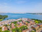 Welcome to this rare full-brick 3-bedroom, 2-bathroom condo located in a quiet and picturesque community in College Point! It&rsquo;s on 2nd Floor, which offering a true house-like layout, this oversized 1, 330 SF second-floor unit features high ceilings, modern renovations, and a sun-drenched open layout perfect for both daily living and entertaining. Interior Highlights: 3 spacious bedrooms & 2 full baths. High vaulted ceilings, updated interiors. Generous living room, large kitchen & formal dining area. Smart toilet, split A/C units, washer/dryer hookup. Private terrace ideal for BBQ or outdoor relaxation. Includes 1 garage parking + 1 outdoor parking space. Community Perks: Just steps from the waterfront promenadeâ€”perfect for walking, jogging, or taking in the views. Close to a local yacht club and surrounded by beautiful parks. Enjoy sweeping Manhattan skyline and water views. Commuter Friendly: Convenient access to Q25 & Q65 buses, offering direct service to Downtown Flushing. Monthly HOA: $380 â€“ includes water, building insurance, roof & exterior maintenance, landscaping, snow removal, garbage, and yard care. Annual Property Tax: $4, 800. Donâ€™t miss your chance to own a rare oversized condo in a premium locationâ€”house-like space at condo pricing!