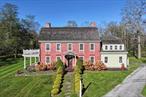 Step back in time without sacrificing modern comforts in this rare, historic brick farmhouse estate, originally built in the 1760s by early settler Sarah Tobias Newcomb. Rich in Revolutionary War-era history, this extraordinary property tells a story few homes can: while Sarah&rsquo;s husband, Zaccheus, fought for the Loyalists, she famously sent cheese from her dairy to George Washington&rsquo;s encampment nearby. Over the years, the home has flown both British and American flags, bearing witness to centuries of change.Set on approximately 18 serene acres with subdivision potential for three 3.5-acre lots, the estate includes a beautifully restored 6-bedroom, 4-bathroom residence. Carefully updated to preserve its character, the home features original wide-plank hardwood floors, massive Dutch doors with original hardware, six corner Rumford fireplaces, designer lighting, crown molding, and a fully renovated chefâ€™s kitchen with an eat-in area. Enjoy formal and casual living spaces, including a dining room, living room, and family room.Modern upgrades include new central air, central vacuum, and oil heating with an above-ground tank. Additional amenities include a soaking tub, stall shower, and dedicated dressing area.Property taxes have been lowered for the 2025 tax season, offering immediate financial reliefâ€”and there is further potential for tax breaks should the new owner choose to start a small farm operation.Outdoors, unwind on the 50-foot veranda overlooking a tranquil pond and rolling pastures. A charming tiny house by a seasonal brook offers extra retreat space, while two large barns serve various purposesâ€”one equipped with horse stalls and a commercial woodworking shop, the other perfect for additional stabling or storage. An outdoor cabana adds another space for relaxation or entertaining.This fully furnished estate (furniture included at asking price or above) is being sold as-is by motivated sellers who have poured love and care into its restoration. Whether you&rsquo;re an equestrian, a history enthusiast, or a visionary investor, this property offers endless potentialâ€”from farming (which may bring additional tax benefits) to development or simply enjoying the luxury of rural elegance.Donâ€™t miss your chance to own a truly one-of-a-kind home where history, charm, and opportunity meet.